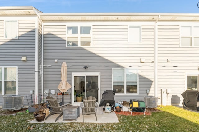 rear view of house featuring cooling unit and a patio