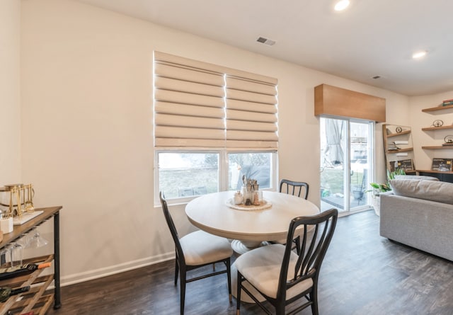 dining area featuring dark wood-type flooring