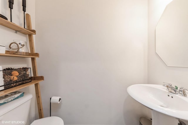 bathroom featuring toilet and sink