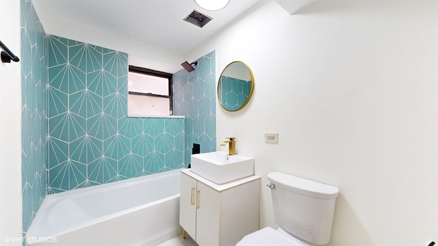 full bathroom with vanity, toilet, and tiled shower / bath