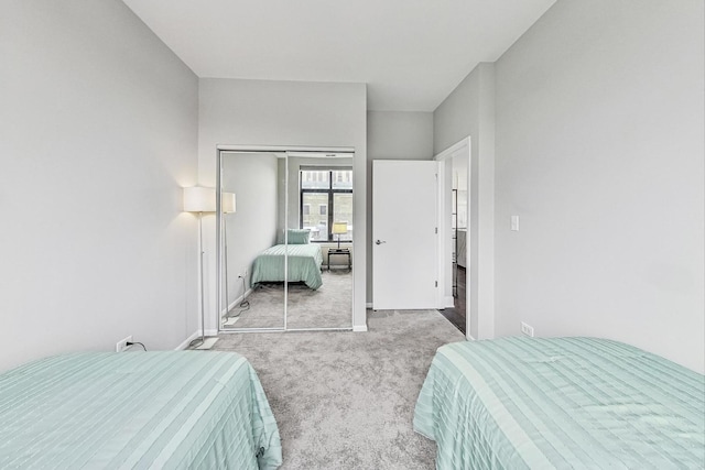 bedroom featuring light carpet and a closet