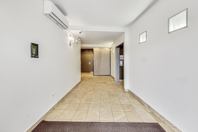 hallway featuring a wall mounted AC and light tile patterned floors