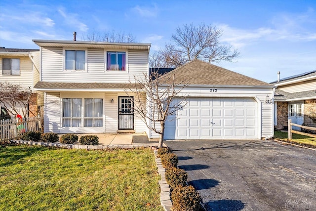 view of property featuring a garage and a front yard