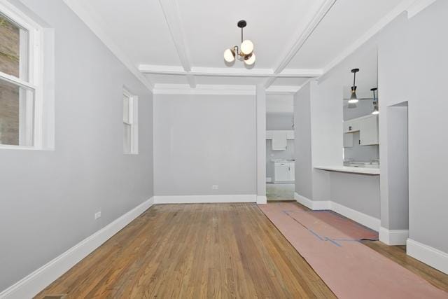 interior space featuring beam ceiling, an inviting chandelier, wood-type flooring, and coffered ceiling