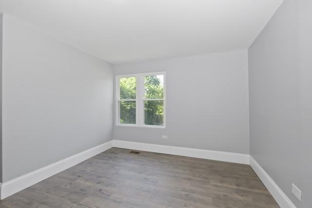 unfurnished room with hardwood / wood-style flooring