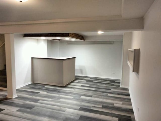 basement with dark hardwood / wood-style flooring