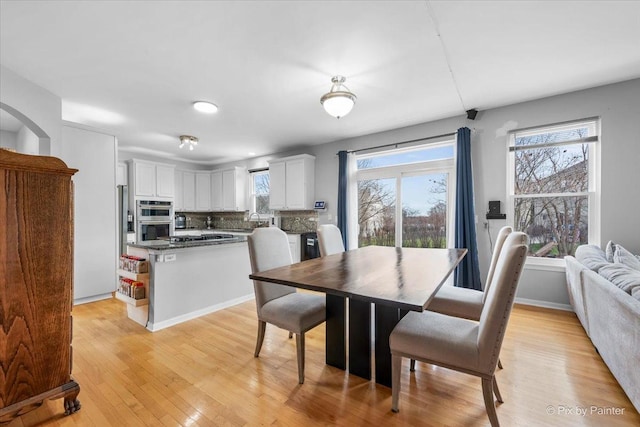 dining area featuring sink and light wood-type flooring