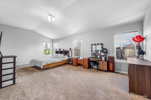 carpeted bedroom featuring lofted ceiling