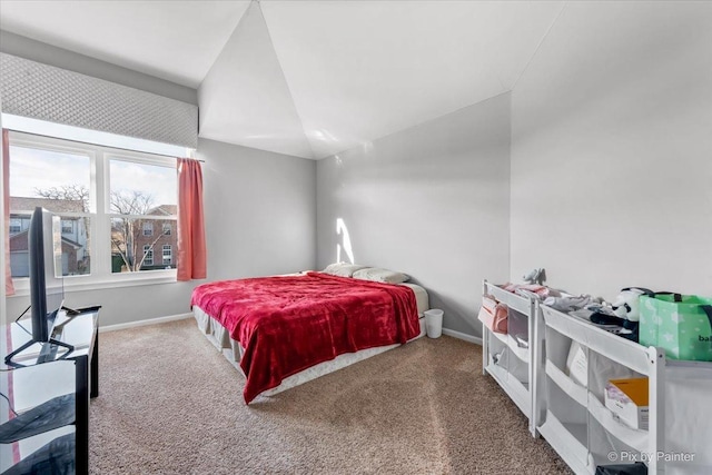 carpeted bedroom with lofted ceiling