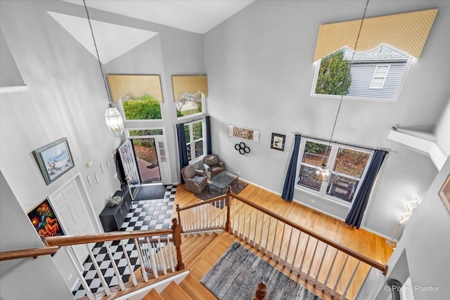 interior space with hardwood / wood-style flooring, high vaulted ceiling, and a healthy amount of sunlight