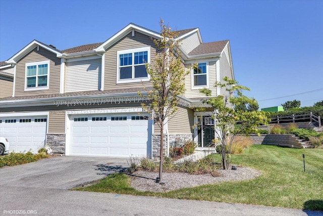 view of front of home with a garage and a front yard