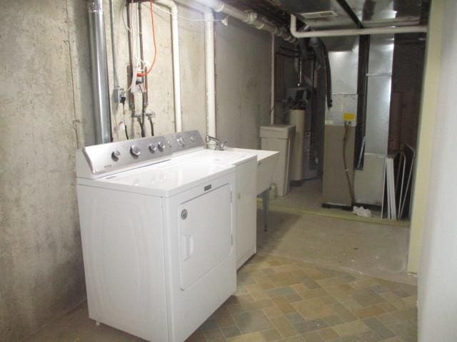 clothes washing area with water heater and washing machine and clothes dryer