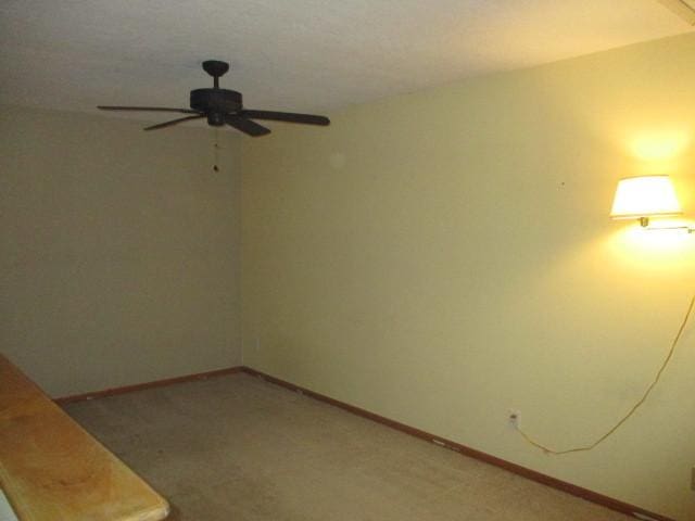 empty room with carpet flooring and ceiling fan