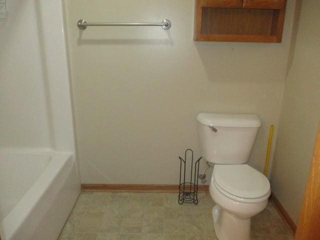 bathroom with a tub and toilet