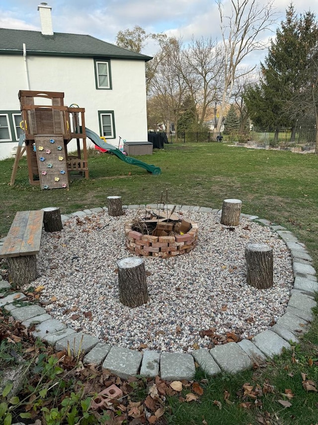 view of yard with a playground and a fire pit