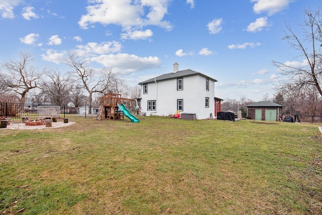 exterior space with a playground and an outdoor fire pit