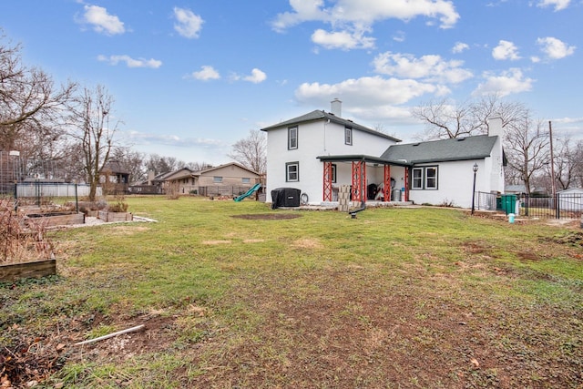 back of property featuring a playground, a yard, and a patio