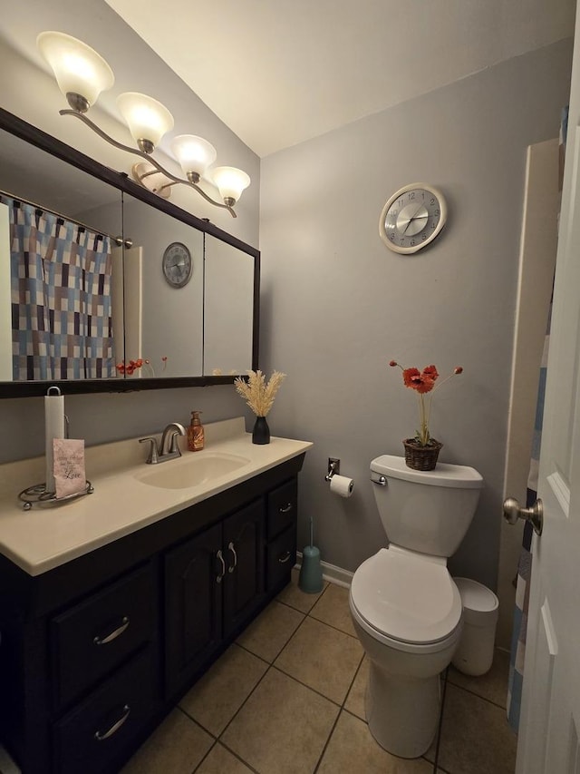 bathroom featuring toilet, tile patterned floors, and vanity