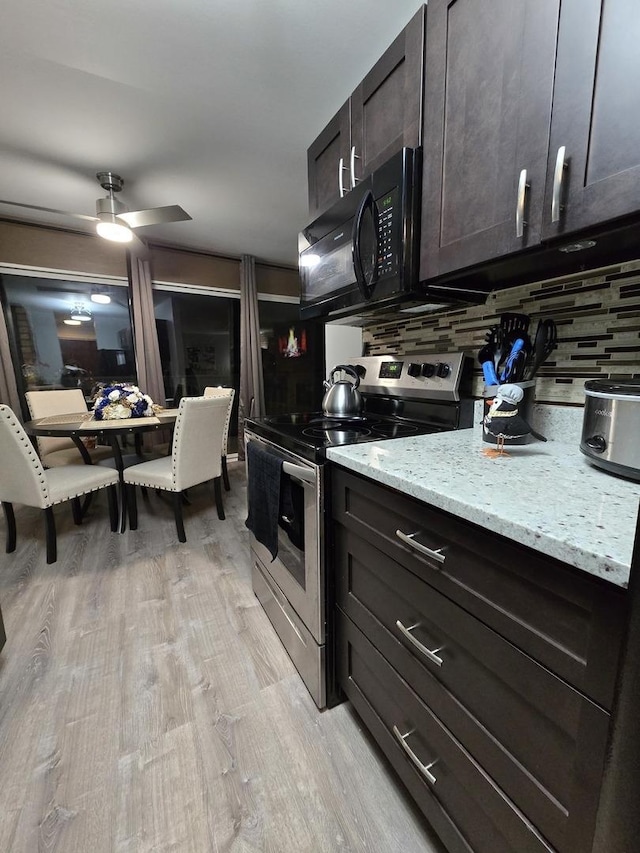 kitchen with tasteful backsplash, light wood-type flooring, stainless steel range with electric cooktop, dark brown cabinets, and light stone counters