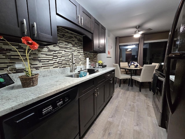 kitchen featuring black dishwasher, light hardwood / wood-style floors, sink, backsplash, and ceiling fan