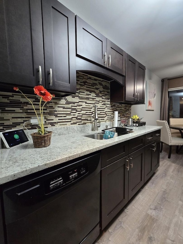 kitchen featuring dishwasher, light hardwood / wood-style flooring, backsplash, and sink