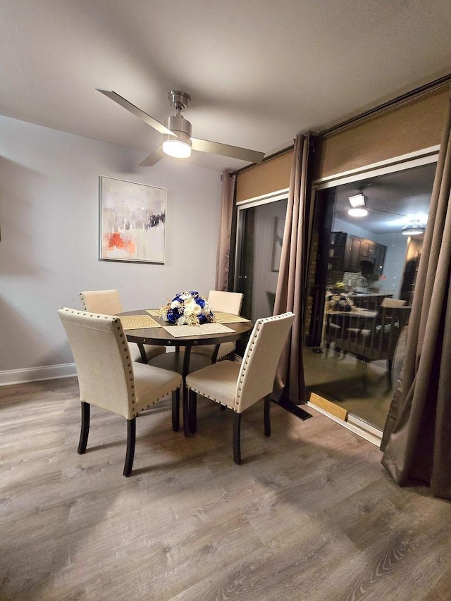 dining space featuring ceiling fan and hardwood / wood-style flooring