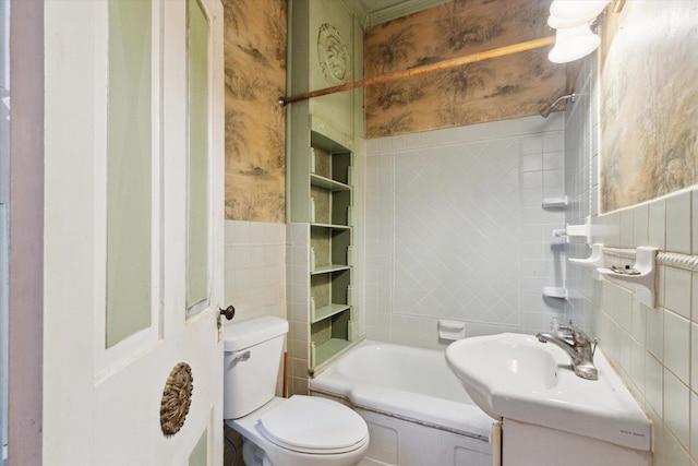 bathroom featuring built in features, vanity, toilet, and tile walls