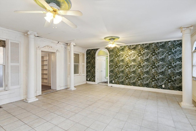 spare room with ceiling fan, ornate columns, and crown molding