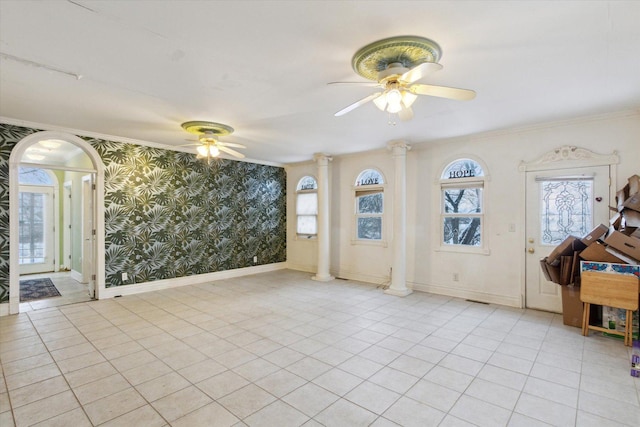 interior space with ornate columns, ceiling fan, and ornamental molding