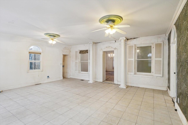 unfurnished room with ceiling fan with notable chandelier, decorative columns, and ornamental molding