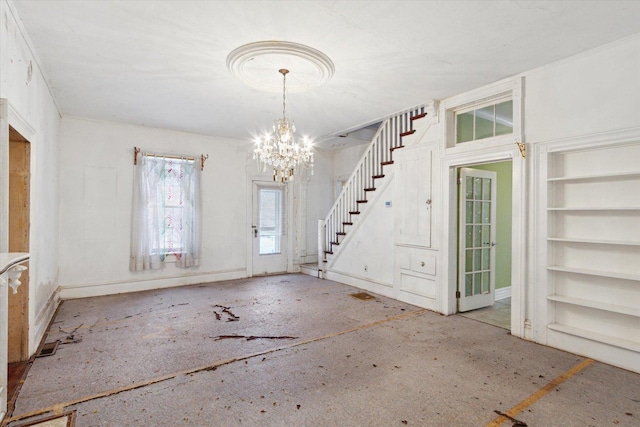 foyer entrance with a notable chandelier