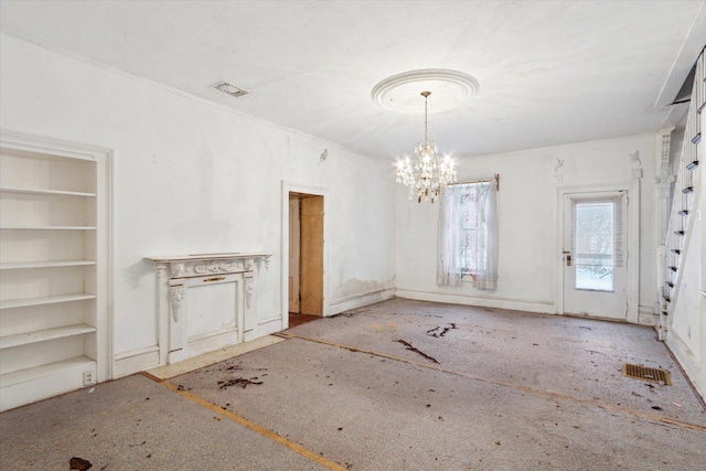 unfurnished dining area with built in shelves and a notable chandelier