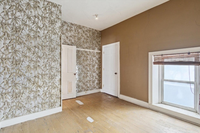 spare room featuring wood-type flooring