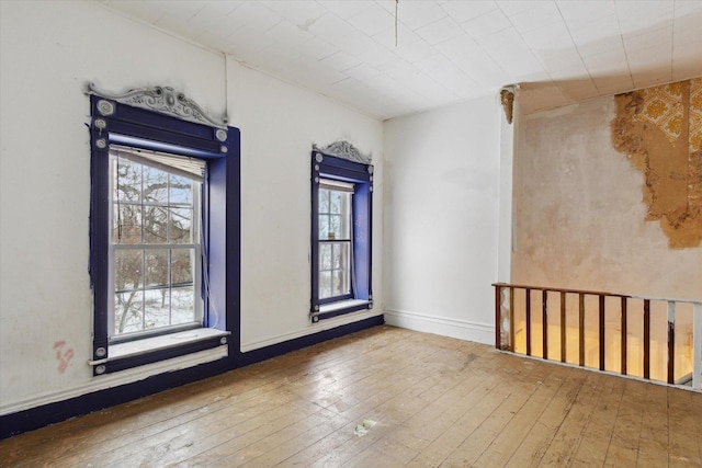 empty room featuring hardwood / wood-style flooring and a healthy amount of sunlight