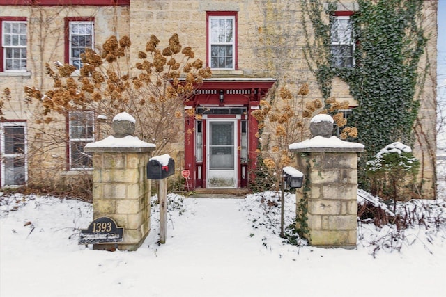 view of snow covered property entrance