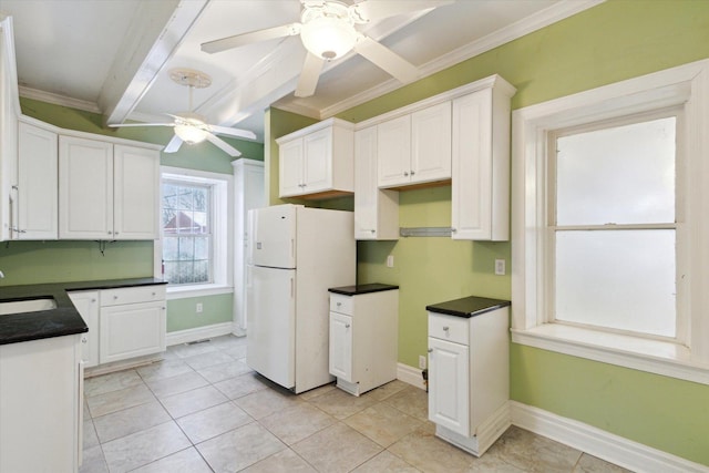 kitchen with white cabinets, white refrigerator, sink, ceiling fan, and ornamental molding