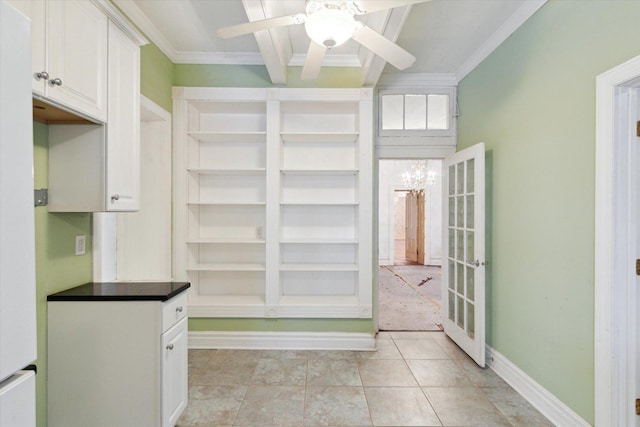 interior space with ceiling fan, crown molding, and light tile patterned floors