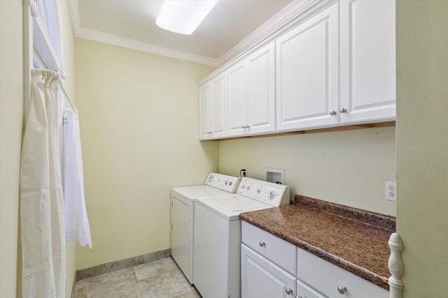 clothes washing area featuring washer and dryer, crown molding, and cabinets