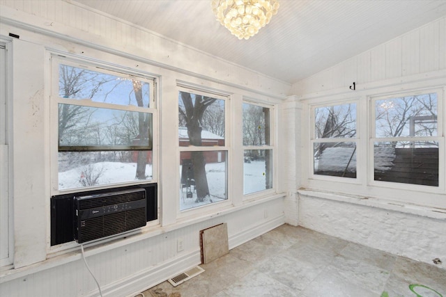 unfurnished sunroom featuring cooling unit, lofted ceiling, and a chandelier