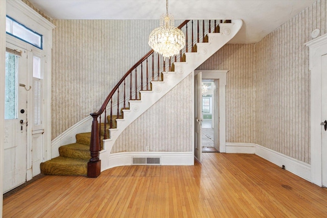 entrance foyer featuring hardwood / wood-style flooring and an inviting chandelier