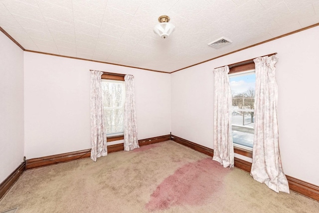 spare room with crown molding and light colored carpet