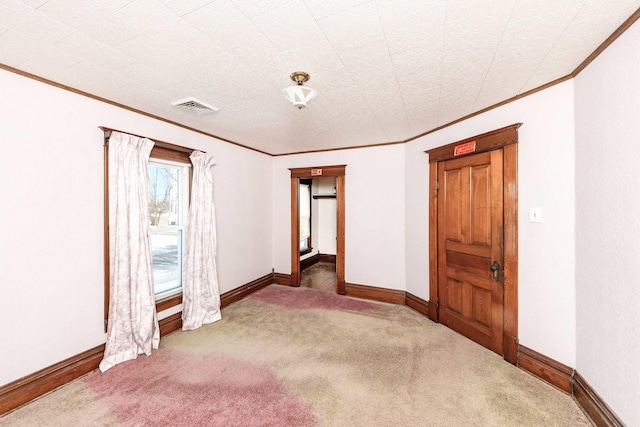 unfurnished room featuring crown molding and dark carpet