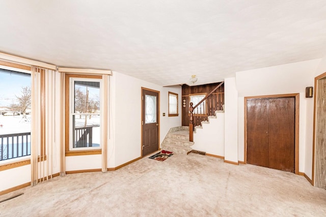 view of carpeted foyer