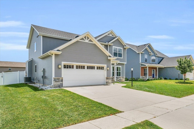 craftsman-style home with a front yard, a garage, and central AC unit