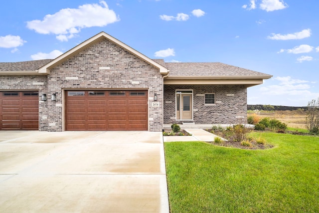 view of front of house with a garage and a front lawn