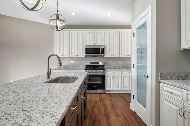 kitchen featuring light stone countertops, sink, white cabinets, and stainless steel appliances