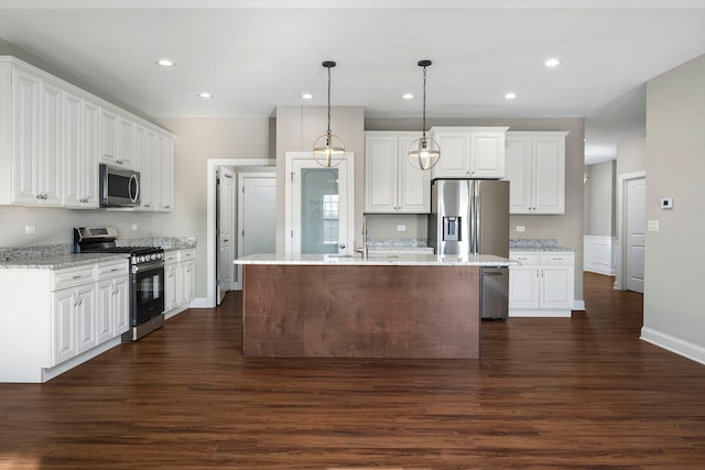 kitchen with white cabinets, pendant lighting, stainless steel appliances, and sink