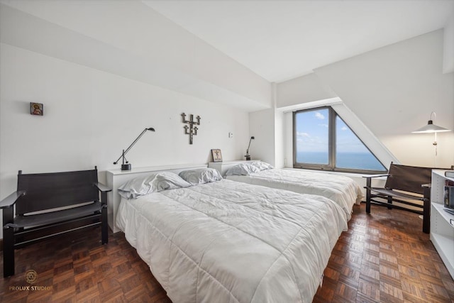 bedroom featuring dark parquet flooring and lofted ceiling