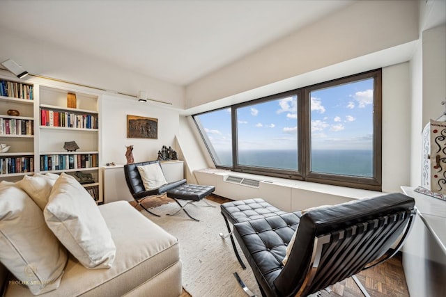 living room featuring a water view and parquet flooring