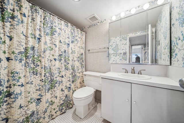 bathroom featuring tile patterned floors, vanity, and toilet